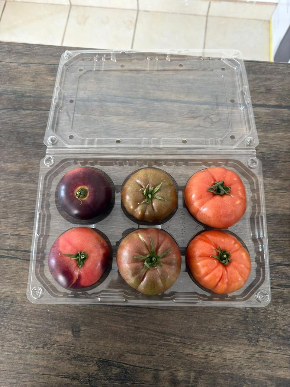 Six heirloom tomatoes in a clamshell